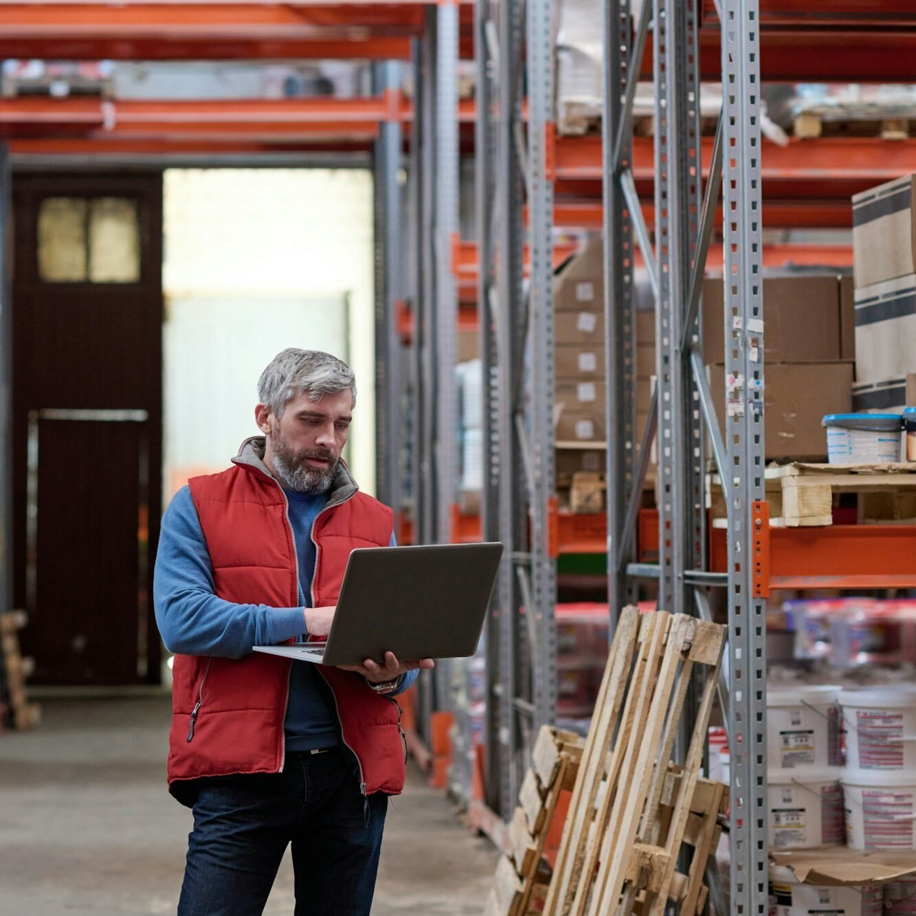 Distributor using laptop at warehouse